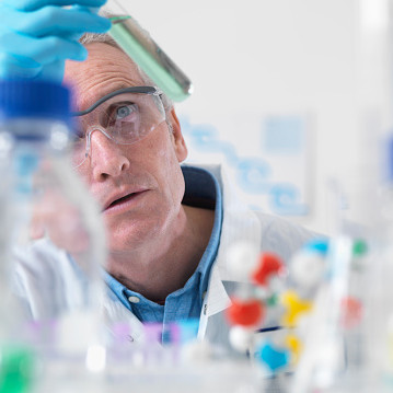 Scientist viewing chemical experiment in laboratory